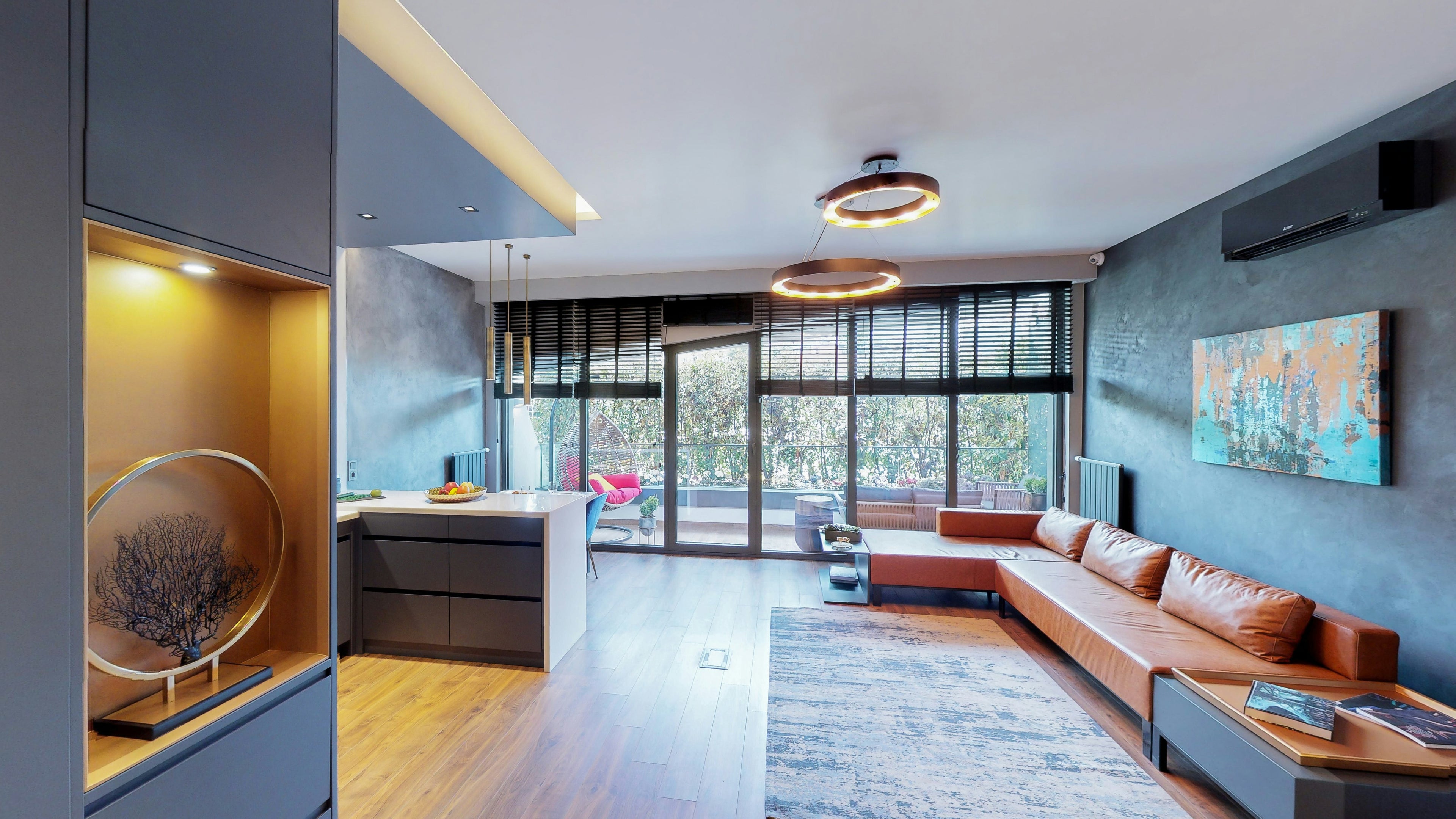 Modern living room with a large window, sofa, and decorative elements by Casa Duah